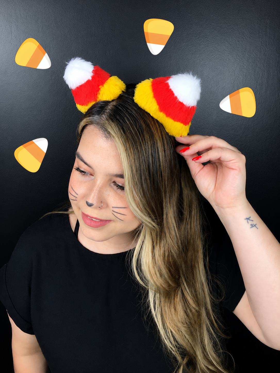 Side view of fluffy candy corn cat ears headband in yellow red and white