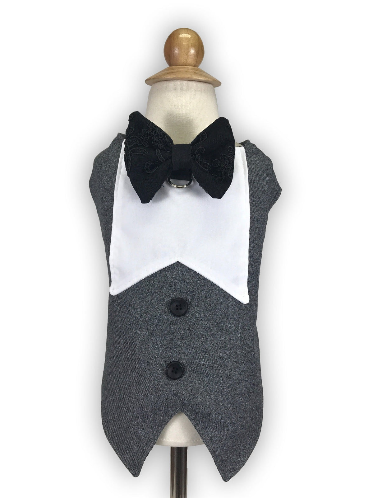 Front view of gray tuxedo dog vest with white collar, black embroidered bow tie, decorative buttons and metal D-ring on a dress form
